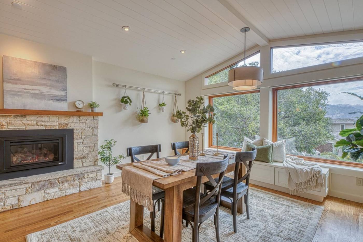 Staged dining room with stone fireplace