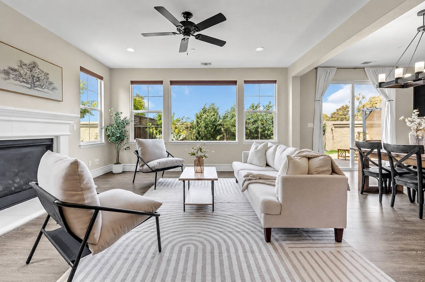 Staged living room with a fireplace and a wall of windows, Carmel